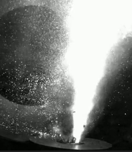 A black and white photo of flames shooting up in the air. 