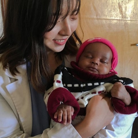 A woman holding a baby