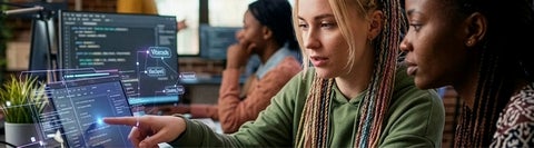Two people working on a laptop together with ai visualization overlays