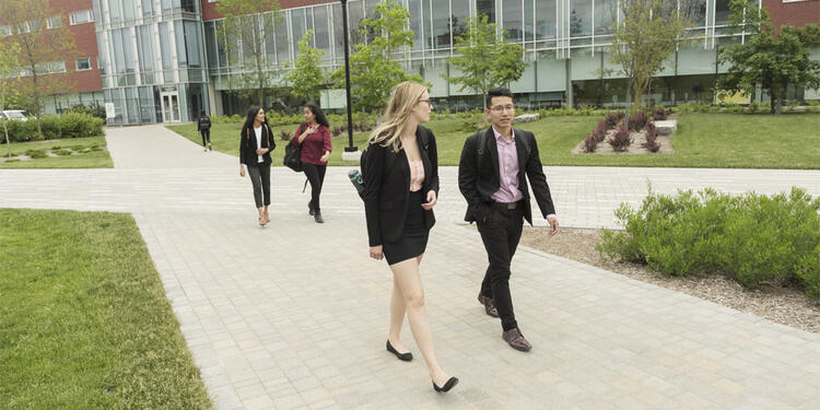 Students in interview attire, walking on campus.