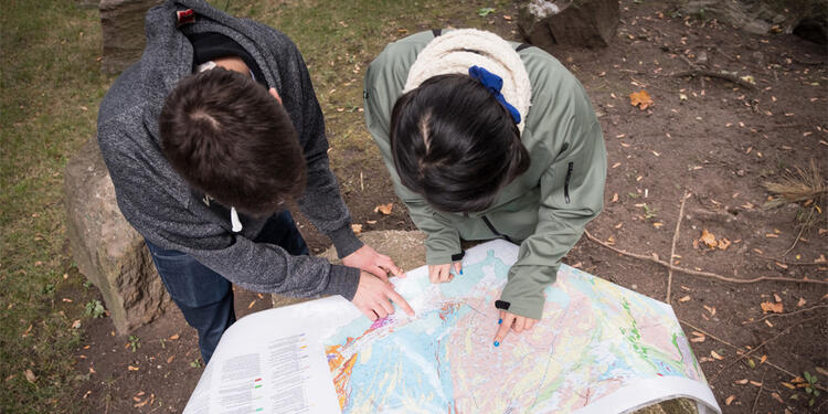 Geoscience students looking at a map.