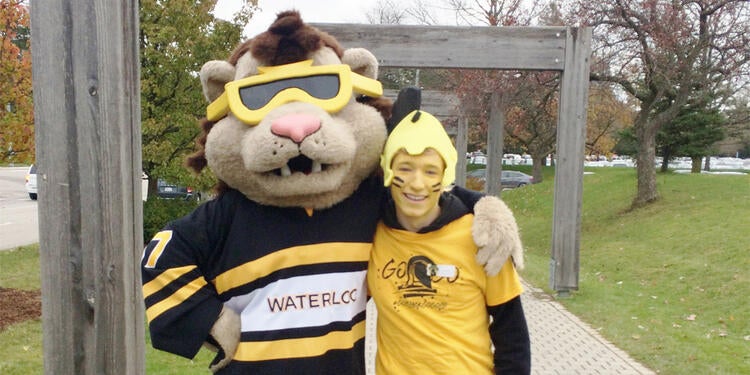A student with the University of Waterloo mascot, King Warrior.