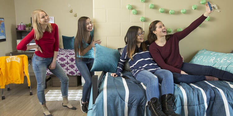 Group of students in residence room.
