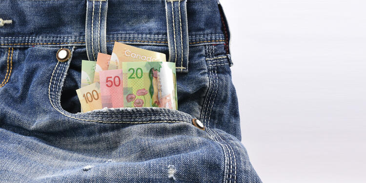 Dollar bills in a jean pocket.