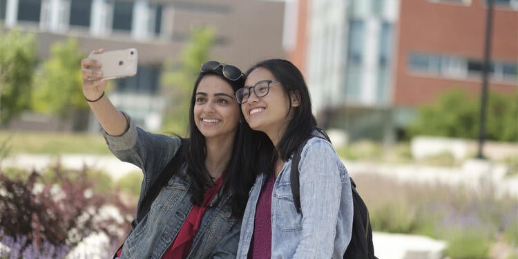 Girls taking a selfie on campus.
