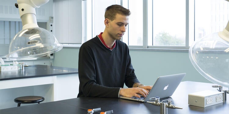Student on a laptop in the lab.
