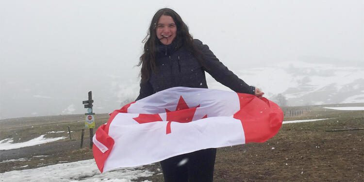 A girl holding a Canadian flag.