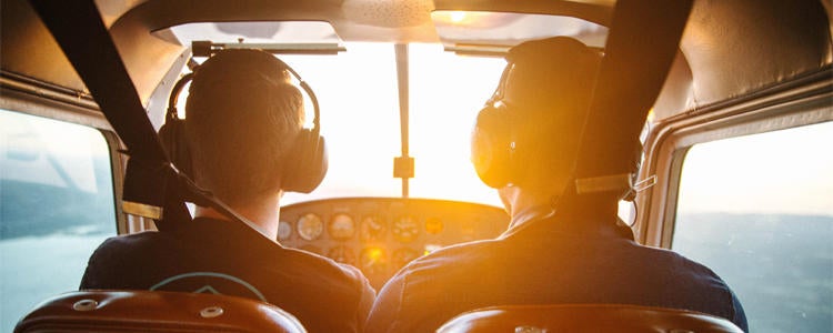Two pilots in a small cockpit. Earn a Bachelor of Science and your commercial pilot's licence.