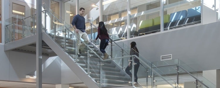 Students walking up stairs in math building