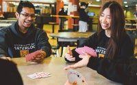 Students playing a game of cards