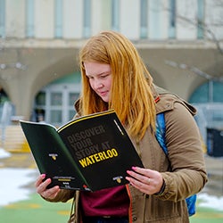 Student reading the Waterloo viewbook