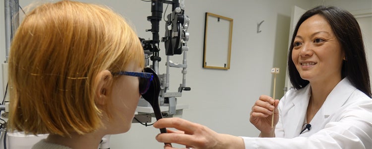 An optometrist doing an eye exam.