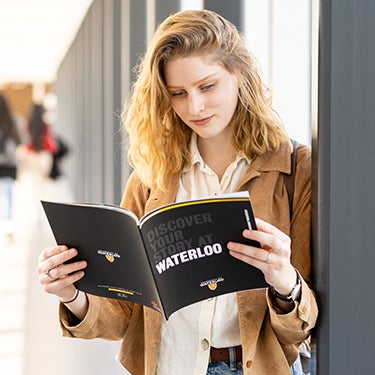 Student holding a brochure
