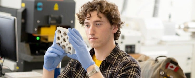 Carson looking at a sample in a lab.