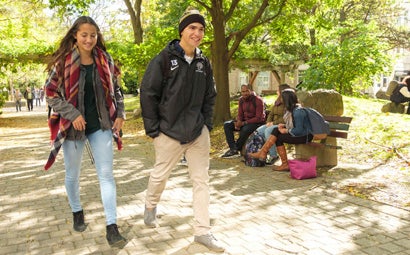 Students walking in a beautiful garden on campus.
