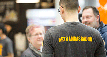 Student wearing shirt that says Arts Ambassador