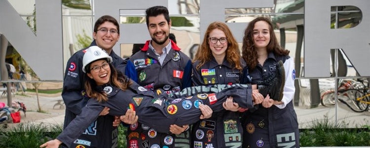 Group of Engineering students wearing coveralls with patches on them