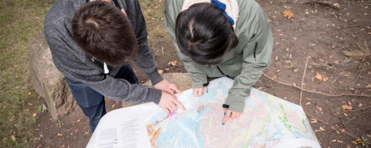 Geoscience students looking at a map.