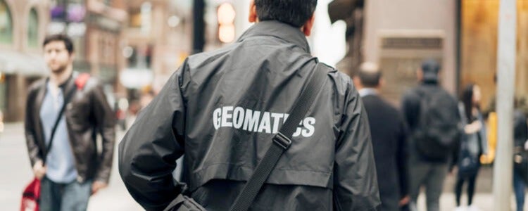 Student wearing a Geomatics program jacket.