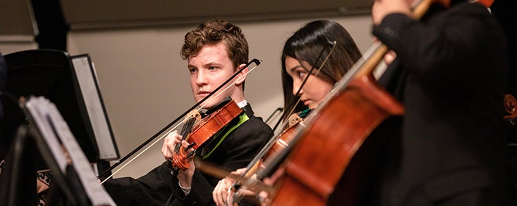 Students playing orchestral instruments