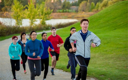 Group of University of Waterloo students running along path