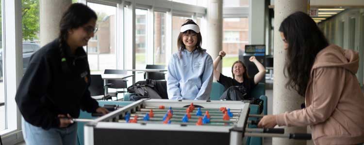 Students playing foosball in residence
