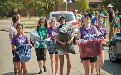 A group of students carrying boxes on move-in day