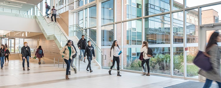 Students walking in a bright atrium at the University of Waterloo