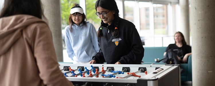 Students playing a game of foosball