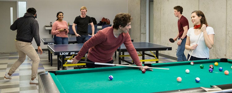 Students playing pool in residence
