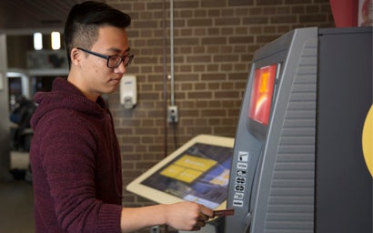 Student using ATM machine.