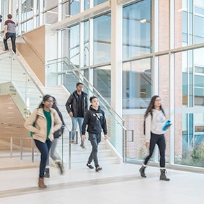 Students walking in a brightly lit atrium