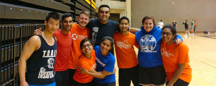 intramural volleyball students posing and smiling in the gym