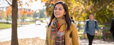 Student wearing coat with fall colours