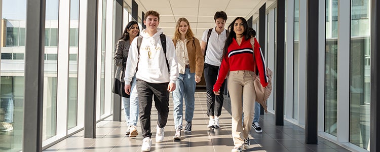 Group of students walking down a hallway