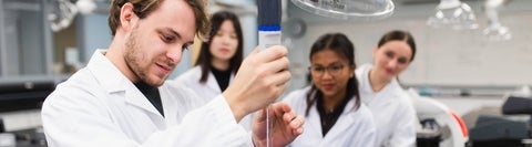 Students in a lab experimenting.