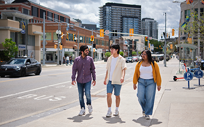 Three students walking together in Uptown Waterloo.