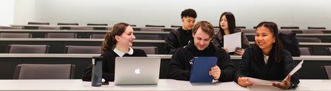 Five students sitting in a lecture hall