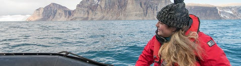 Student sitting on a boat in the arctic