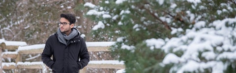 student walking in the snow