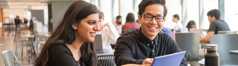 Two students sitting together in SLC.