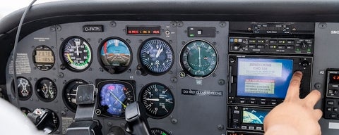 A close up of plane controls in the cockpit.