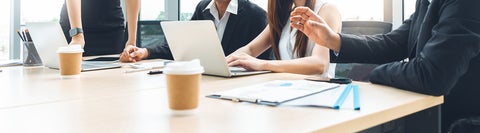 Four professionals sitting at a business meeting.