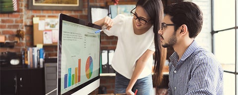A person pointing at a graph on a computer