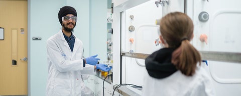 Two students working together in a lab.