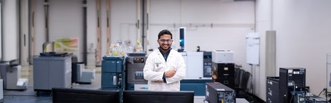 University of Waterloo biochemistry student in a lab full of equipment