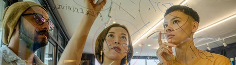 Students writing on a whiteboard