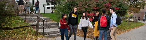 Group of five students standing together on Waterloo's campus