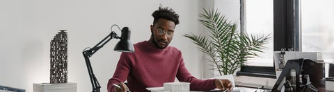 Co-op student working at a desk with papers all over