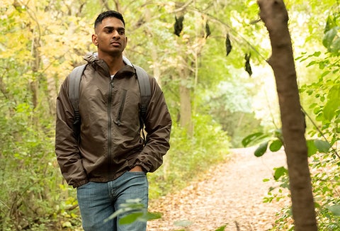 Student walking through a forest